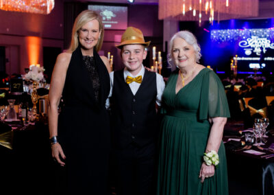 Melissa Doyle AM, Nate Nelson and Carmel Crouch AM posing in formal attire.